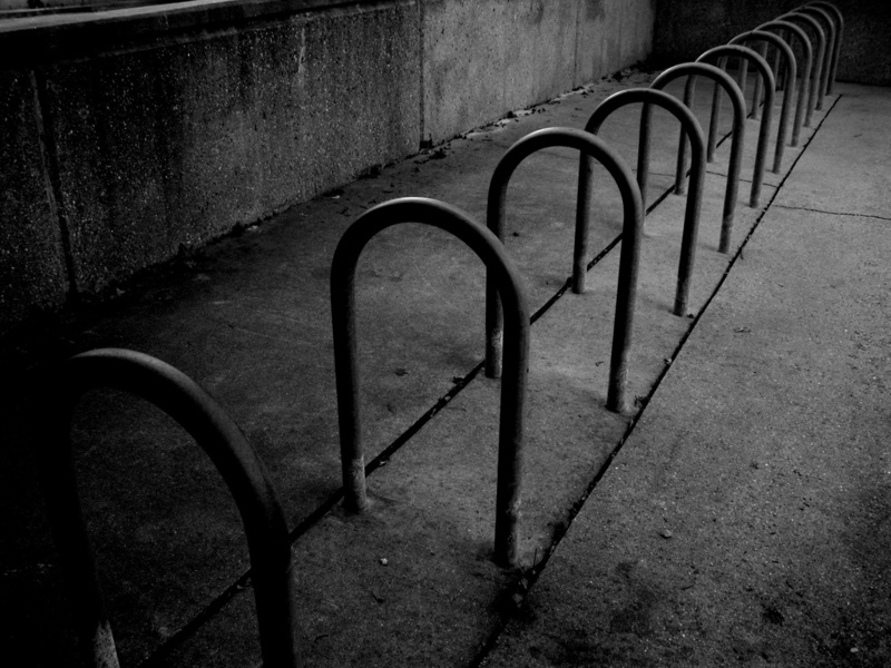 transportation, footpath, shadow, rack, metal, curve, bike rack, wall, shapes, absence, black and white, wisconsin, bicycle rack, bike, no people, empty