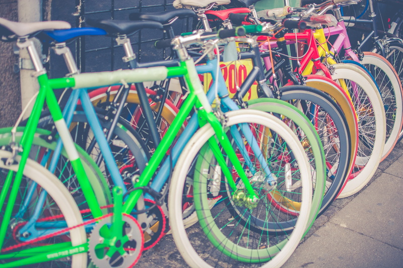 mode of transportation, stationary, outdoors, multi colored, street, day, parking, architecture, red, city, metal, in A Row, bicycle, urban Scene, lifestyles