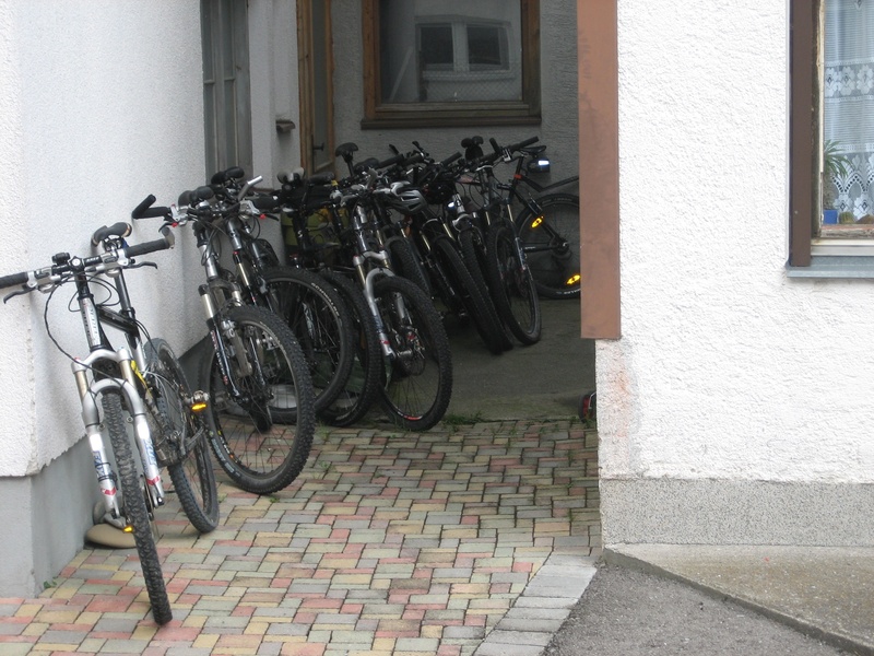 transalp, mode of transportation, parking, wheel, sidewalk, building, 2K, bike, outdoors, bicycle rack, street, door, day, built structure, building exterior