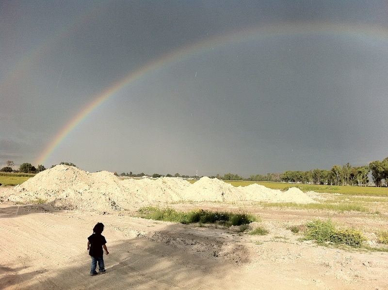 beauty in nature, real people, field, outdoors, tranquility, nature, landscape, leisure activity, sky, standing, double rainbow, day, environment, rainbow
