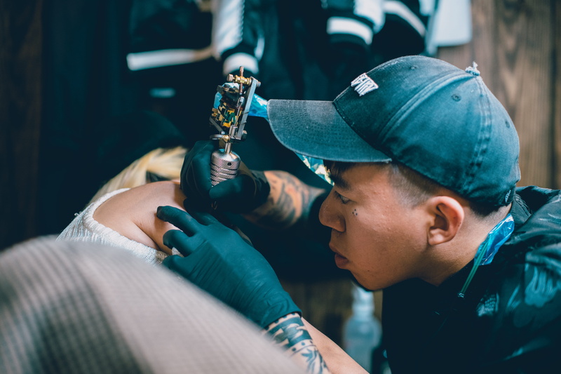 clothing, clinic, indoors, skin, apparel, two people, machine, focus on foreground, taiwan, protection, helmet, hat, cap, young adult, factory, hardhat