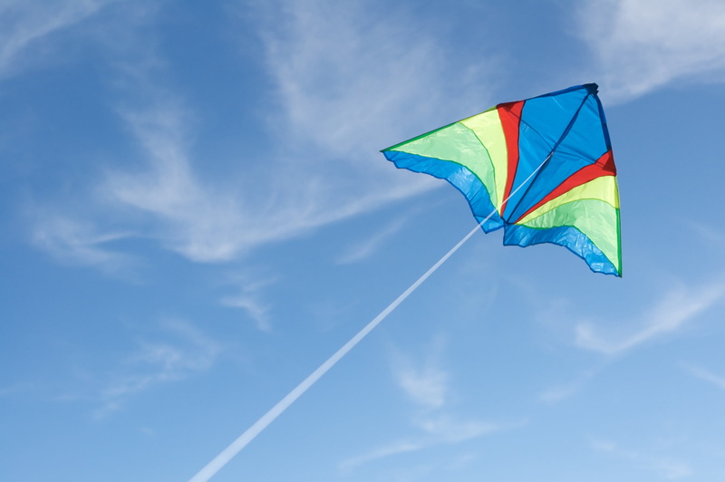flying, emotion, day, motion, striped, 2K, no people, cloud - sky, flight, kite - toy, sky, nature, multi colored, low angle view, blue, mid-air, environment