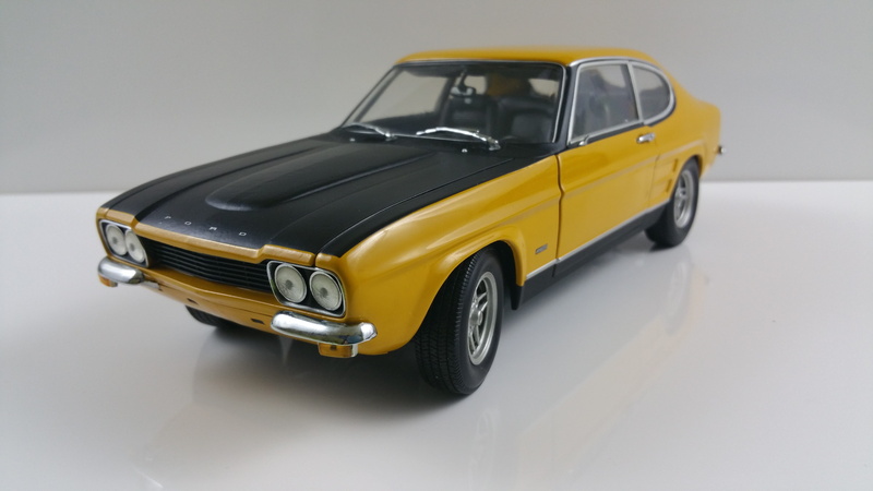 model, city, single object, model car, wheel, studio shot, coupe, toy, 5K, land vehicle, displayed, yellow, indoors, taxi, motor vehicle, die, vehicles