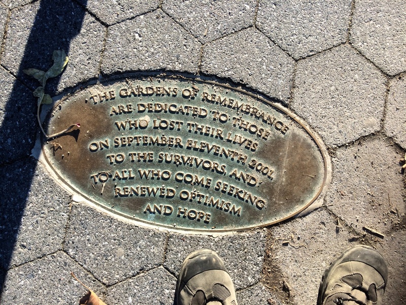 2K, circle, paving stone, western script, memory, communication, standing, human leg, 911, low section, one person, street, body part, shoe, manhole, city