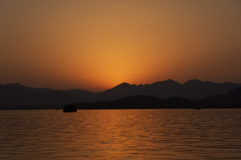 dusk, sunset, west lake, china, silhouette, waterfront, no people, outdoors, tranquility, mountain, boat, orange color, water, last light, romantic sky