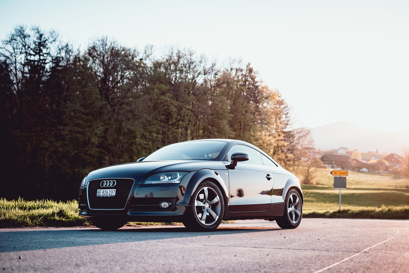 parked, luxury, sportscar, landscape, wheel, german, sign, near, motion, coupe, day, travel, trees, no people, wealth, road marking, road trip, marking