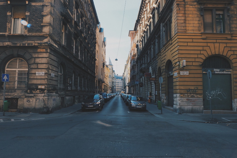 building, direction, buildings, stationary, diminishing perspective, concrete road, daytime, streets, architecture, concrete, road, building exterior, mode of transportation