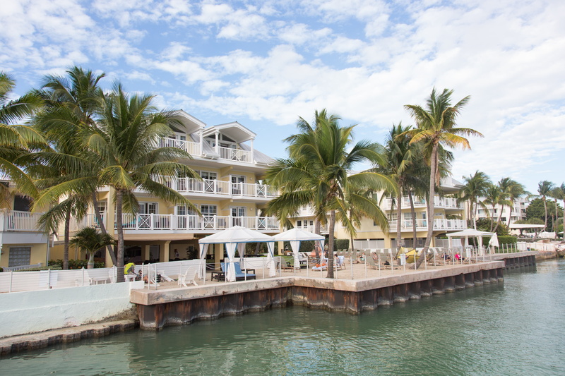 growth, water, palm tree, destination, hotel, key west, building, nature, plant, pool, no people, waterfront, architecture, cloud - sky, tree, tourist resort