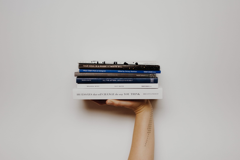 adult, read, text, human hand, wall, studio shot, human body part, communication, pile, books, one person, finger, holding, indoors, white, retro styled