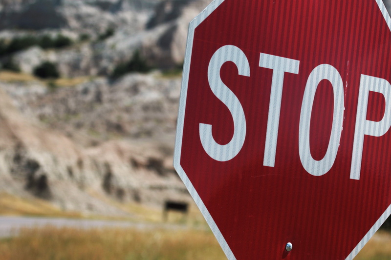 western script, red, driving, symbol, sign, warning sign, road, communication, highway, road sign, Stop Sign, white color, text, no, no people, day, warning