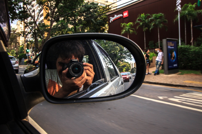 pavement, photography themes, motor vehicle, land vehicle, reflection, real people, camera, one person, side mirror, leisure activity, camera lens, photo