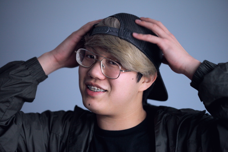 hairstyle, human face, hair, black, person, human hair, casual clothing, headshot, 5K, hands, glasses, adult, cap, braces, front view, happiness, real people