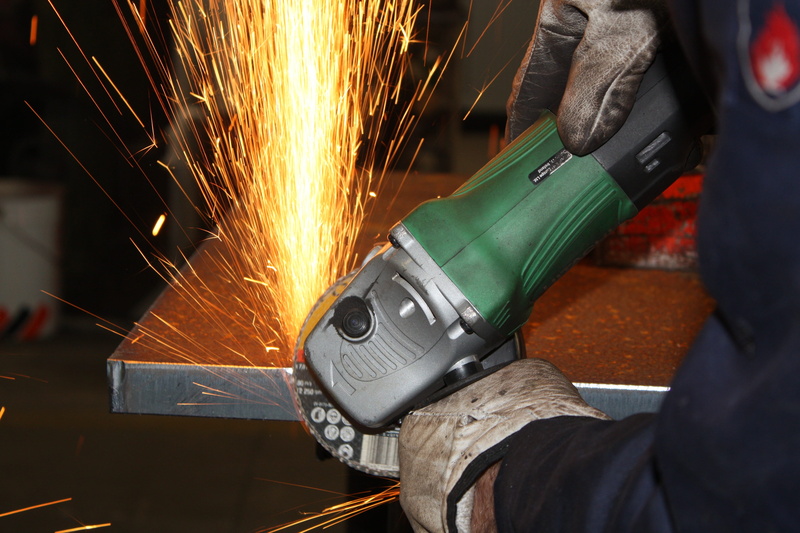 metallurgy, blurred motion, iron - metal, protective workwear, metal, men, workshop, equipment, working, hand, one person, holding, industry, indoors, welding
