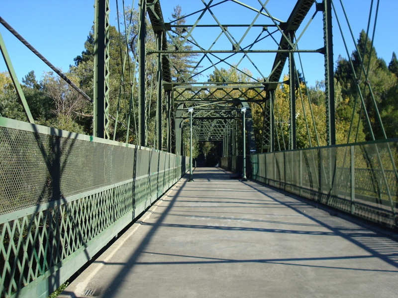 ironwork, sky, connection, diminishing perspective, tree, outdoors, transportation, design, no people, built structure, the way forward, metal, bridge - man made structure
