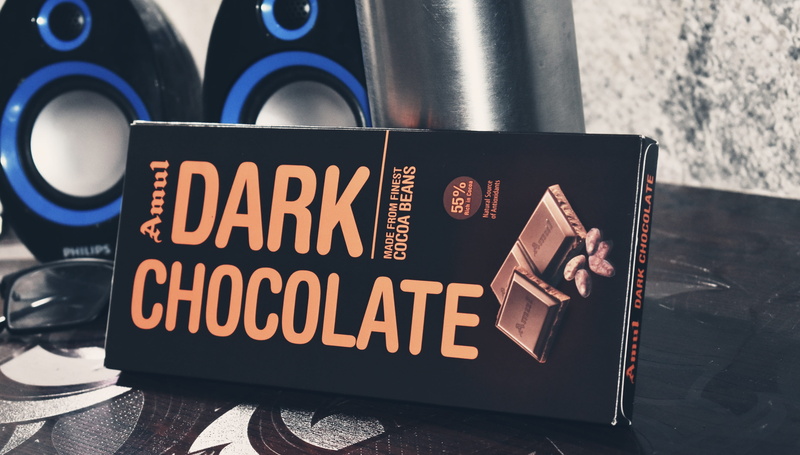 speakers, focus on foreground, text, sign, treat, chocolate, day, food and drink, amul, dark, no people, table, capital letter, communication, desk, black color
