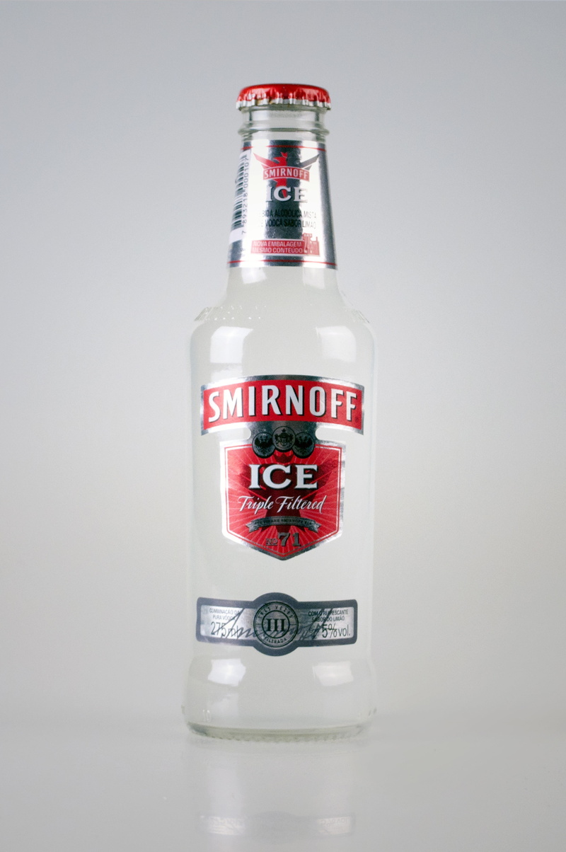 gray background, indoors, bottle, text, colored background, food and drink, non-alcoholic beverage, red, label, packing, single object, transparent, drink
