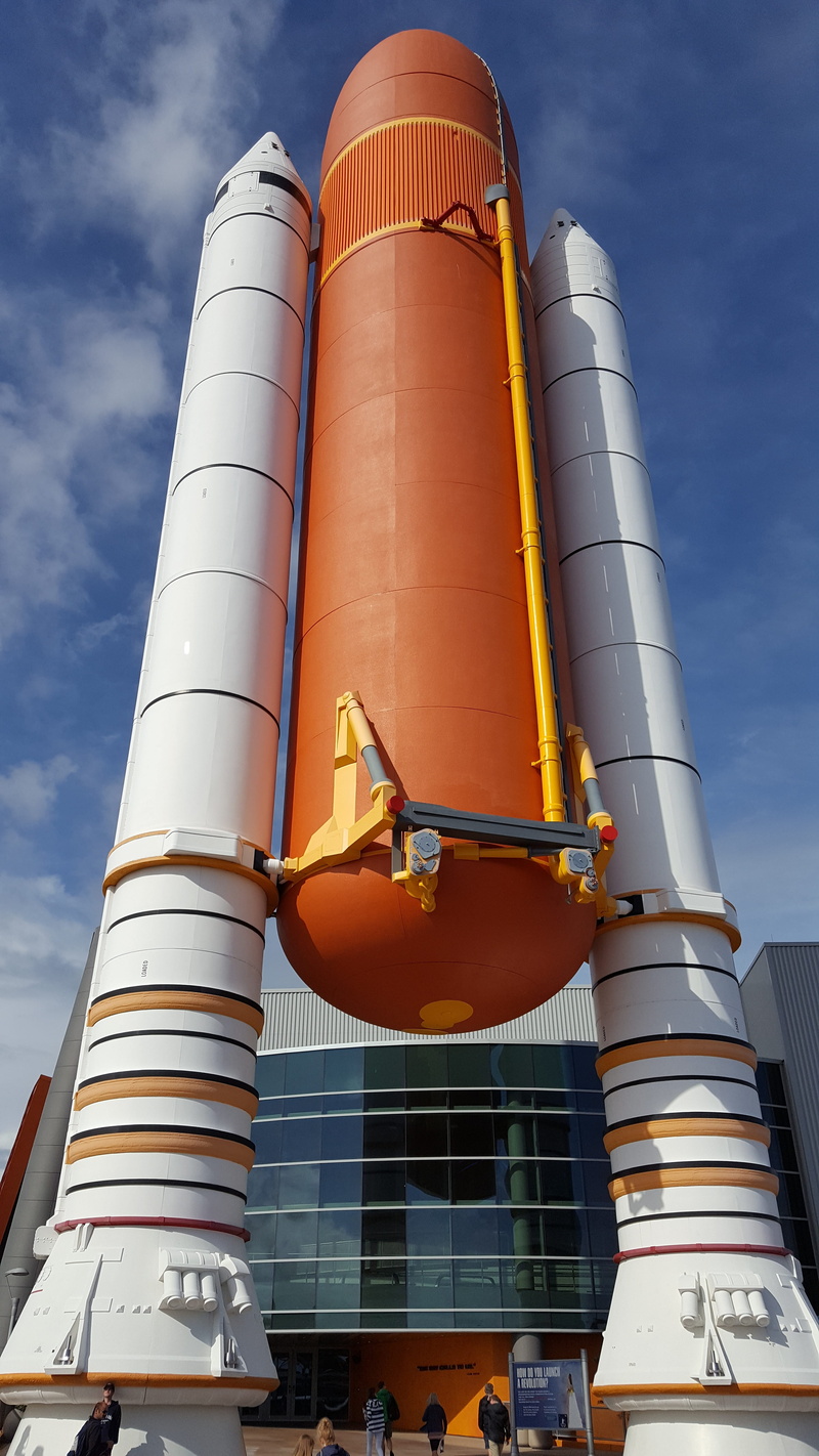 nature, blue, flight, ship, architecture, shuttle, space, outdoors, factory, nasa, science, religion, white, orange, spaceship, day, built structure, sunlight
