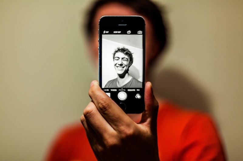 smile, mode, smiling, photo, portrait, photography themes, communication, technology, red, finger, grayscale, smartphone, selfie, man, holding, iphone