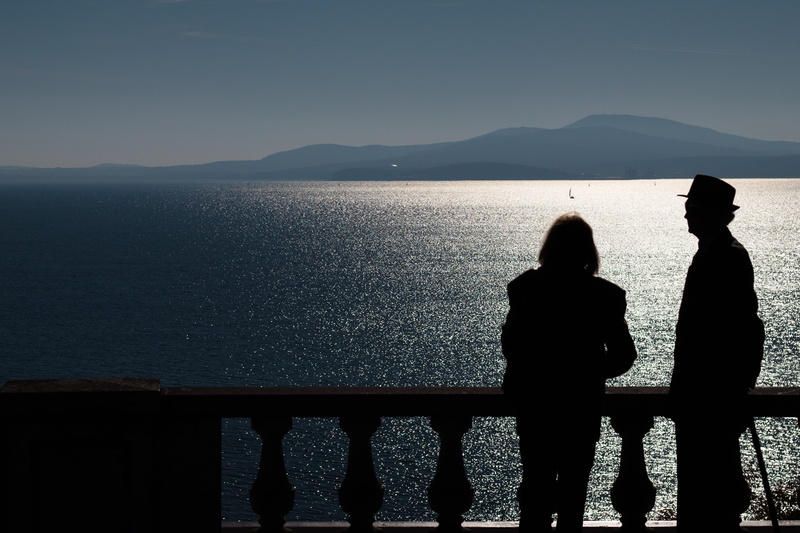 beauty in nature, outdoors, ocean, adult, classic, history, sky, blue, images, looking at view, men, railing, lens, photograph, camera, people, couple