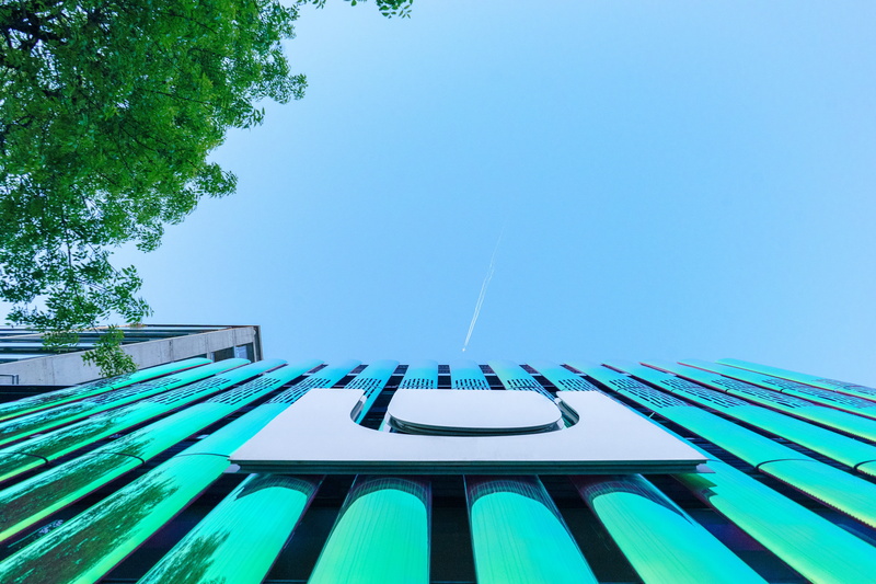 sunlight, low angle view, built structure, directly below, sky, sun, looking up, architecture, design, blue, growth, light, luxury, day, technology, store
