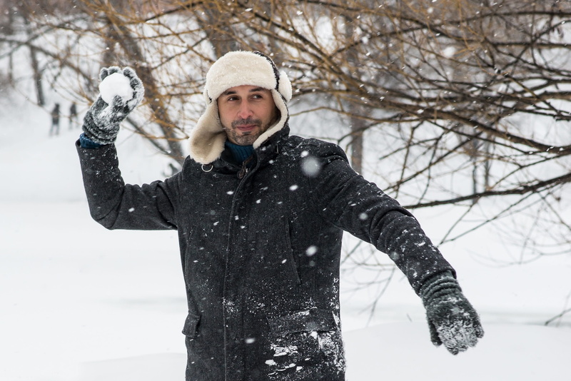one person, beard, trees, snowball, snowballs, playing, men, cold, young adult, looking at camera, fur coat, playing in the snow, adult, males, outdoors