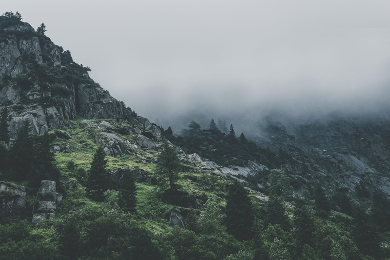 mountain, sky, environment, mountain range, wilderness, beauty in nature, gloomy, land, scenics - nature, tranquil scene, outdoors, rock, dawn, forest