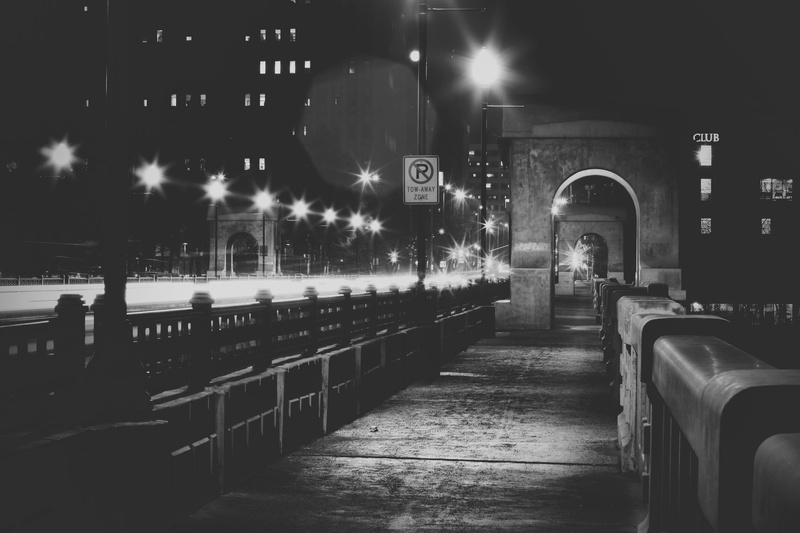 in a row, railing, vintage, land vehicle, city, old, the way forward, fog, buildings, illuminated, street light, night, empty, grey, blackandwhite, mode of transportation