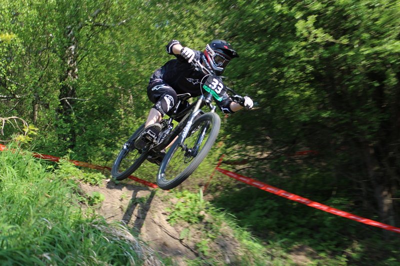 headwear, downhill, helmet, speed, ride, outdoors, motorcycle, one person, leisure activity, tree, skill, competition, activity, obstacles, cyclist, games