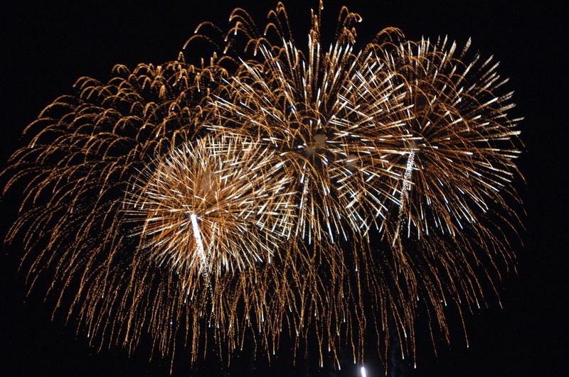 gold, sky, pyrotechnics, firework display, blurred motion, illuminated, night, light, black background, outdoors, new years day, annual financial statements