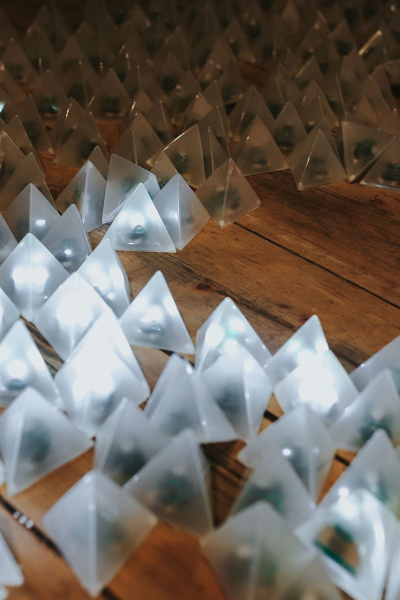 high angle view, white color, art and craft, triangle, creativity, table, large group of objects, pattern, origami, light, little, lights on, focus on foreground