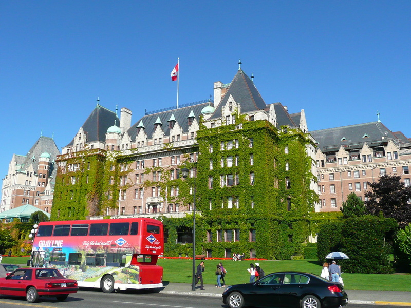 land vehicle, hotel, nature, travel, outdoors, city, plant, empress hotel, clear sky, scenic, canada, building exterior, patriotism, flag, history, Double-Decker Bus