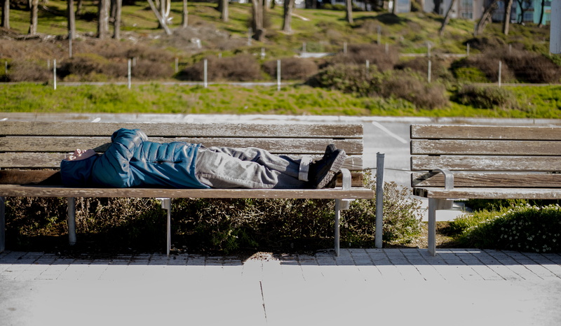wood, furniture, resting, sunlight, lying on back, day, lying, bench, sitting, social issues, casual clothing, architecture, human, handrail, seat, relaxation