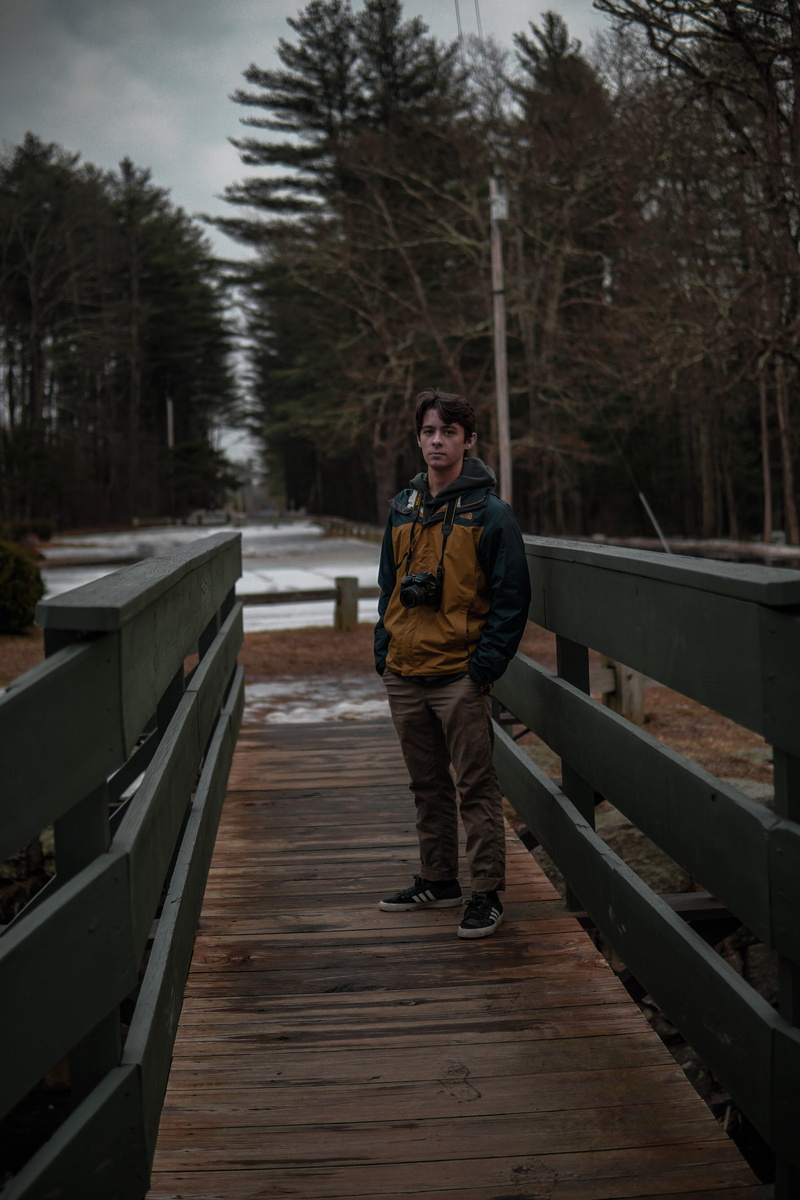 footwear, bridge, real people, water, pier, one person, boardwalk, waterfront, pants, front view, portrait, human, shoe, teenager, apparel, tree, winter