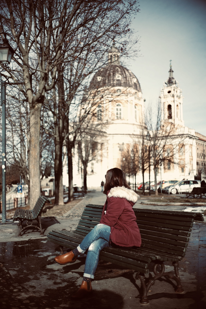 warm clothing, sitting, spirituality, furniture, architecture, path, one person, tree, footwear, spire, built structure, transportation, person, car, clothing