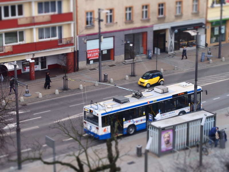 real people, building, incidental people, outdoors, bus stop, city, high angle view, street, architecture, land vehicle, building exterior, road, vehicles