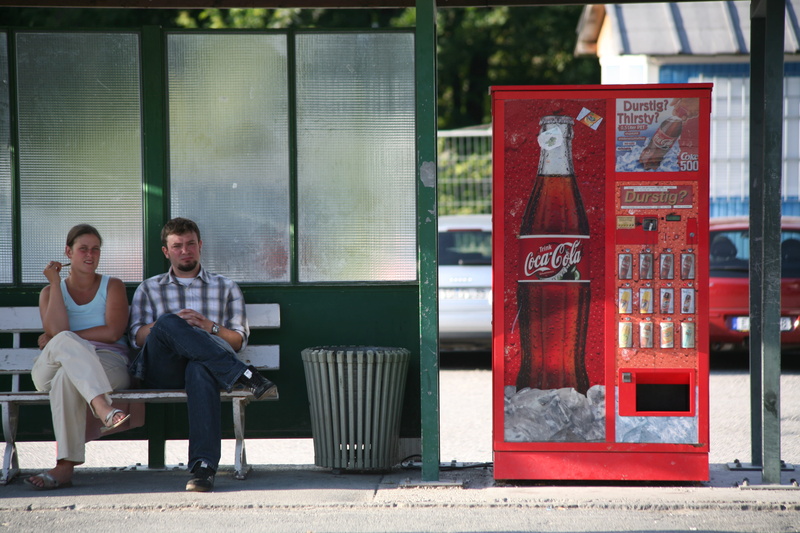 outdoors, laptop, transportation, sitting, men, waiting, young men, street, day, shoe, wireless technology, young adult, human, vending machine, architecture