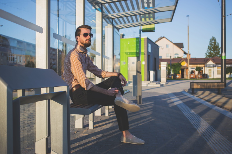 seat, architecture, sunglasses, day, waiting shed, wearing, young men, man, fashion, leisure activity, one person, young adult, stop, person, adult, nature