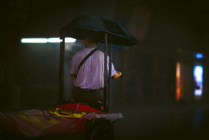 tire, wet, 8K, flooring, sunlight, guangzhou, finger, rainy season, three quarter length, silhouette, beige, real people, rain, canopy, light, illuminated
