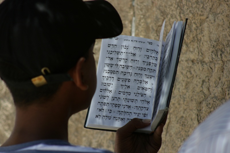 over the shoulder view, text, portrait, faith, communication, rear view, jews, holding, real people, education, man, judaism, human body part, paper, book