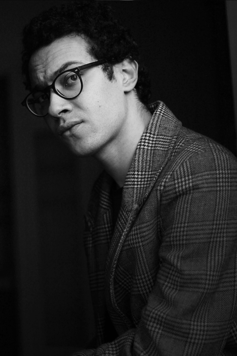 person, glasses, boy, sad, checked pattern, male, one person, 5K, young adult, face, light, headshot, studio, studio shot, casual clothing, curly hair
