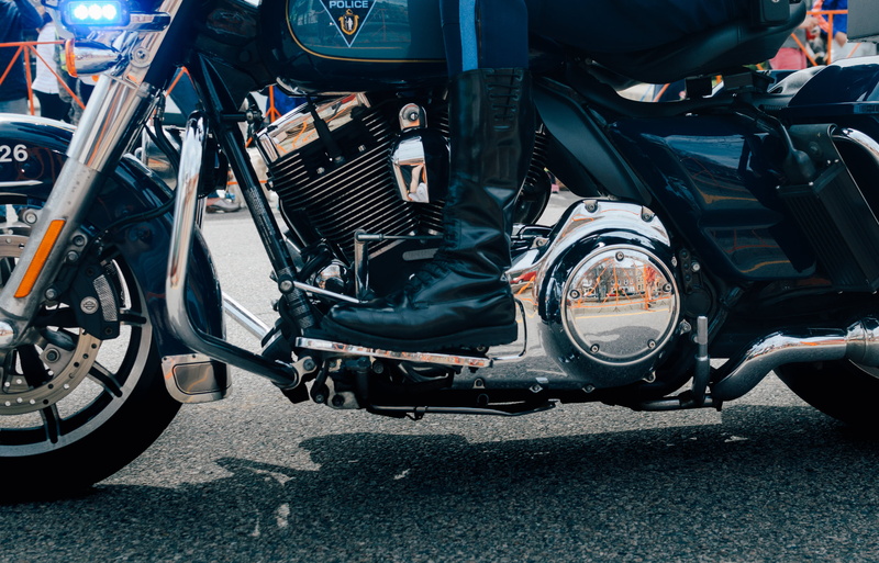 motorcycle, car, high angle view, vehicle, mode of transportation, machine, body part, transportation system, human limb, asphalt, metal, power, motor vehicle
