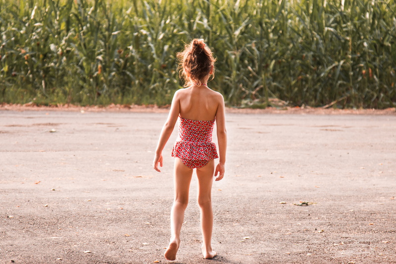 full length, outdoors, one person, onepiece, walking, girls, wearing, girl, childhood, corn, real people, rear view, land, one piece swimsuit, teenager