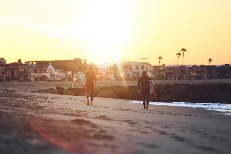 surfboards, outdoors, carrying, men, sport, adult, sky, land, lens flare, silhouette, shore, people, city, 4K, sand, ocean, sunlight, houses, lifestyles
