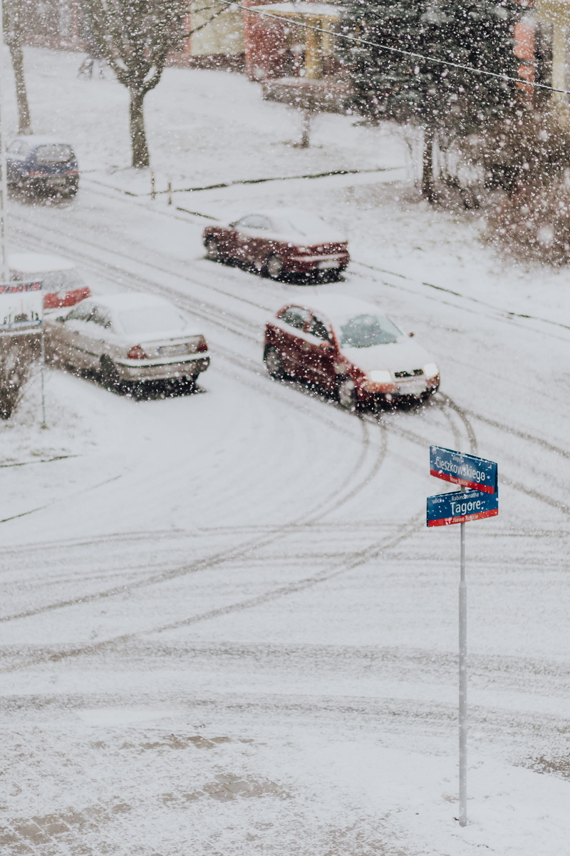4K, transportation, white color, no people, snowy, outdoors, white, city, communication, western script, day, street, nature, snowing, road, sign, text