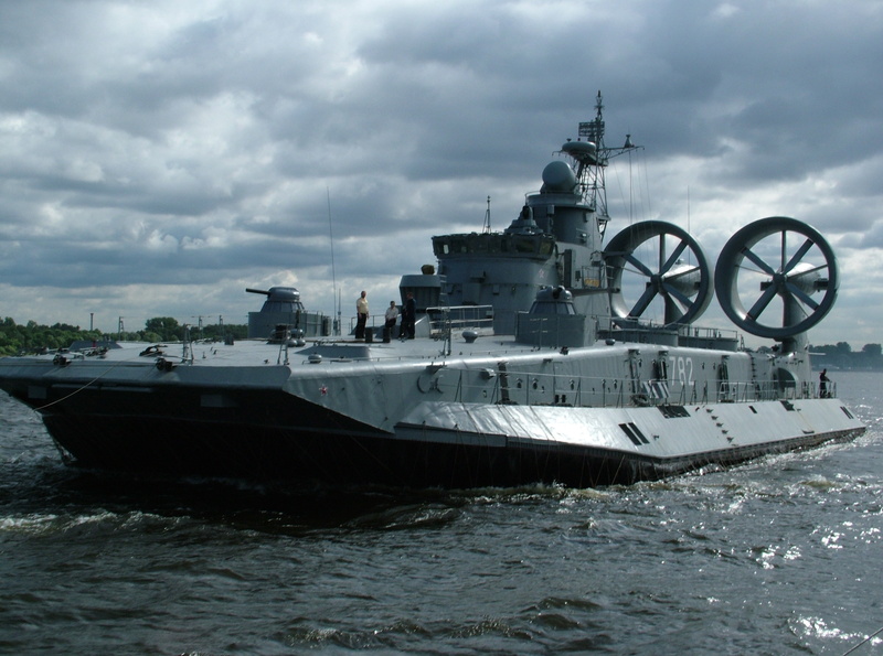 weapon, day, outdoors, moored, nautical vessel, no people, mode of transportation, waterfront, overcast, cloud - sky, sea, military, cruise ship, navy
