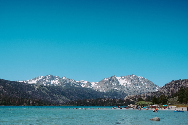 tranquil scene, swim, blue, real people, tranquility, scenics - nature, copy space, leisure activity, beauty in nature, non-urban scene, water, snowcapped mountain