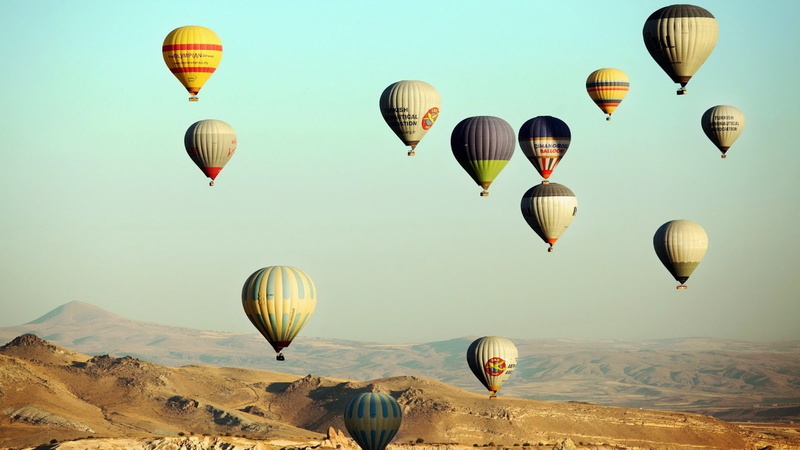 non-urban scene, air vehicle, mode of transportation, day, balloon, adventure, landscape, hot air balloon, flying, multi colored, beauty in nature, travel