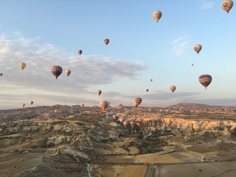 Mountain, no people, beauty in nature, tourism, flying, sky, rock formation, ballooning festival, rock, transportation, rock - object, Turkey, solid, Cappadocia