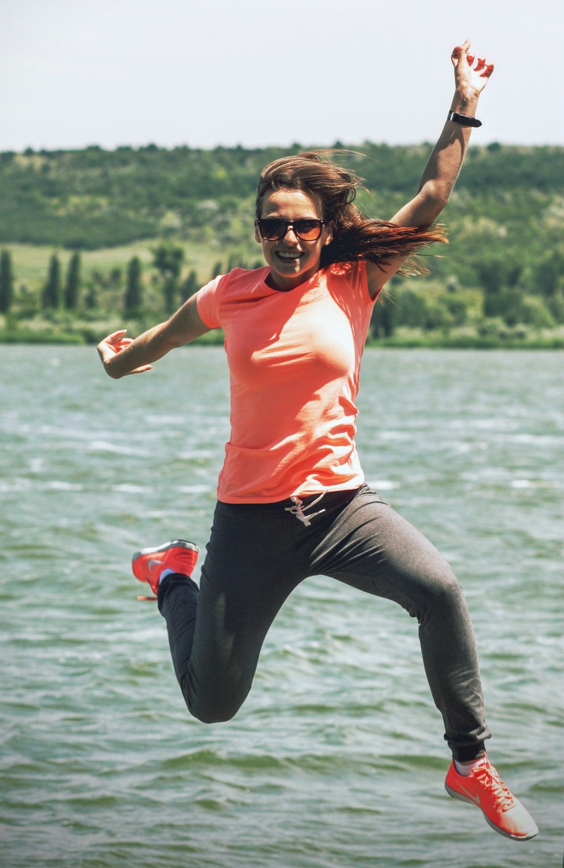 real people, jump, in the air, action, jumping, daytime, arms outstretched, activity, 2K, woman, lifestyles, nature, nike, success, near, body, joy, focus on foreground