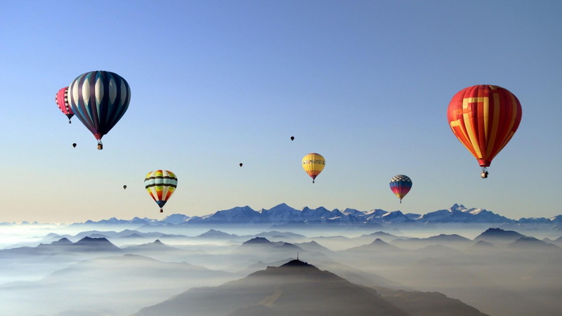 flying, mountain, hills, nature, outdoors, multi colored, mid-air, blue, transportation, sky, mountains, air vehicle, freedom, yellow, mountain range, baloon